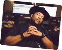 Sir Mix-A-lot sitting in a recording studio.